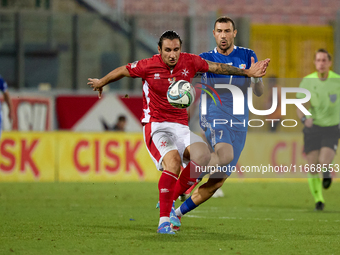 In Ta' Qali, Malta, on October 13, 2024, Kurt Shaw of Malta protects the ball from Artur Ionita of Moldova during the UEFA Nations League, L...