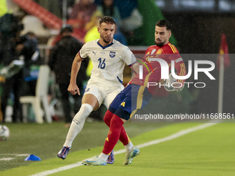 Strahinja Erakovic of Serbia competes for the ball with Alex Baena of Spain during the UEFA Nations League 2024/25 League A Group A4 match b...