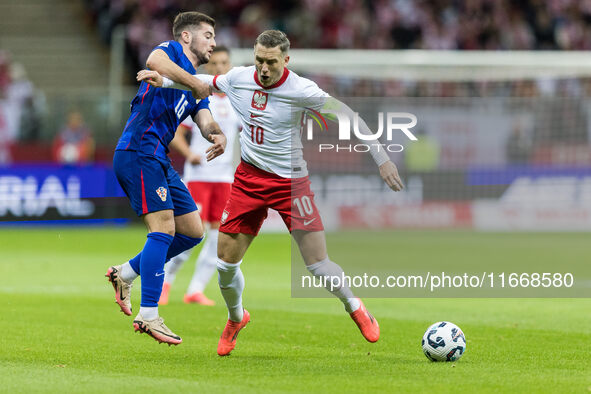 Martin Baturina , Piotr Zielinski  during UEFA Nations League match Poland vs Croatia in Warsaw Poland on 15 October 2024. 