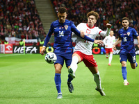 Ivan Perisic of Croatia and Nicola Zalewski of Poland during UEFA Nations League football match Poland - Croatia at National Stadium in Wars...