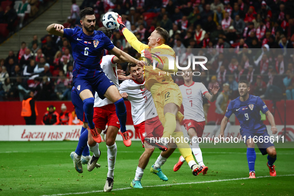 Josip Sutalo of Croatia and Marcin Bulka of Poland during UEFA Nations League football match Poland - Croatia at National Stadium in Warsaw,...