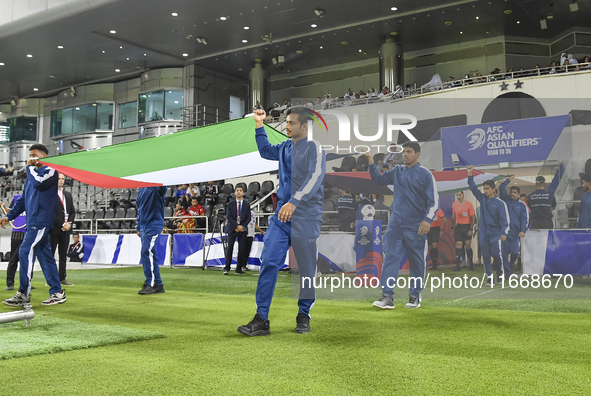 Palestine and Kuwait players walk onto the pitch before the FIFA World Cup 2026 Qualification 3rd Round group B match between Palestine and...