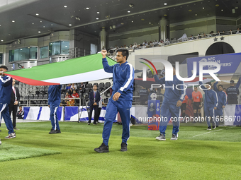 Palestine and Kuwait players walk onto the pitch before the FIFA World Cup 2026 Qualification 3rd Round group B match between Palestine and...