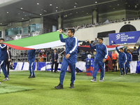 Palestine and Kuwait players walk onto the pitch before the FIFA World Cup 2026 Qualification 3rd Round group B match between Palestine and...