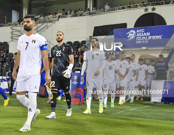 Palestine and Kuwait players walk onto the pitch before the FIFA World Cup 2026 Qualification 3rd Round group B match between Palestine and...