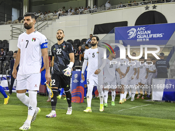 Palestine and Kuwait players walk onto the pitch before the FIFA World Cup 2026 Qualification 3rd Round group B match between Palestine and...