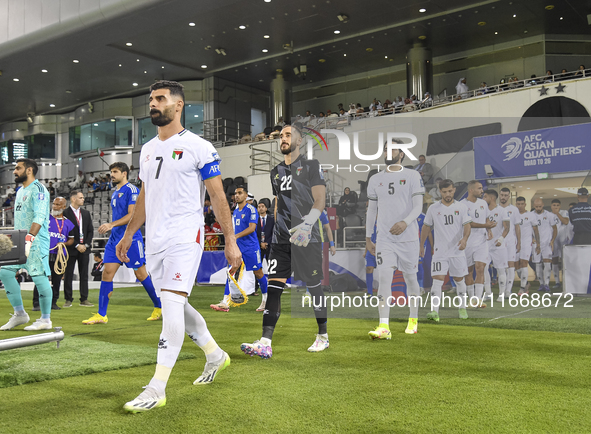 Palestine and Kuwait players walk onto the pitch before the FIFA World Cup 2026 Qualification 3rd Round group B match between Palestine and...