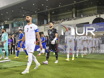 Palestine and Kuwait players walk onto the pitch before the FIFA World Cup 2026 Qualification 3rd Round group B match between Palestine and...