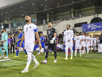 Palestine and Kuwait players walk onto the pitch before the FIFA World Cup 2026 Qualification 3rd Round group B match between Palestine and...