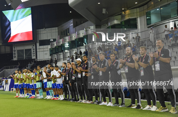 Juan Pizzi, head coach of Kuwait, his staff, and substitutes line up for the national anthem before the FIFA World Cup 2026 Qualification 3r...