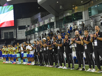 Juan Pizzi, head coach of Kuwait, his staff, and substitutes line up for the national anthem before the FIFA World Cup 2026 Qualification 3r...