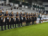 Makram Daboub, Head Coach of Palestine, his staff, and substitutes line up for the national anthem before the FIFA World Cup 2026 Qualificat...