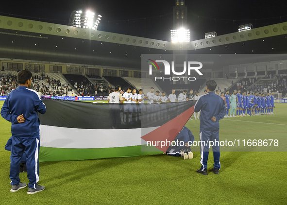 Palestine (left) and Kuwait (right) team players line up before the FIFA World Cup 2026 Qualification 3rd Round group B match between Palest...