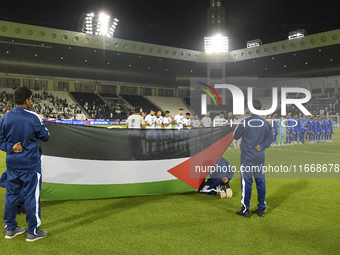 Palestine (left) and Kuwait (right) team players line up before the FIFA World Cup 2026 Qualification 3rd Round group B match between Palest...