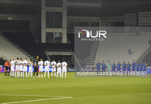 Players observe a moment of silence before the FIFA World Cup 2026 Qualification 3rd Round group B match between Palestine and Kuwait at Jas...