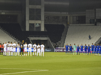 Players observe a moment of silence before the FIFA World Cup 2026 Qualification 3rd Round group B match between Palestine and Kuwait at Jas...