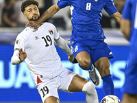 Wessam Abouli of Palestine competes for the ball with Ahmad Aldhefiri of Kuwait during the FIFA World Cup 2026 Qualification 3rd Round group...