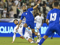 Wessam Abouli of Palestine competes for the ball with Ahmad Aldhefiri of Kuwait during the FIFA World Cup 2026 Qualification 3rd Round group...