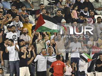 Palestine supporters cheer for their team during the FIFA World Cup 2026 Asian Qualifiers third round group B match between Palestine and Ku...