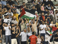 Palestine supporters cheer for their team during the FIFA World Cup 2026 Asian Qualifiers third round group B match between Palestine and Ku...