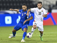 Mahmoud Abuwarda of Palestine battles for the ball with Meshari Alenezi of Kuwait during the FIFA World Cup 2026 Qualification 3rd Round gro...