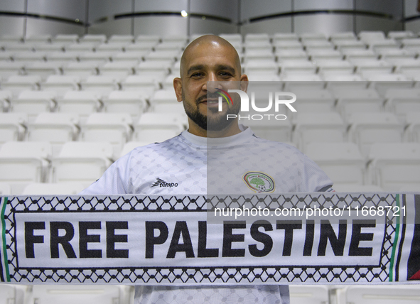 A supporter of Palestine cheers for their team before the FIFA World Cup 2026 Qualification 3rd Round group B match between Palestine and Ku...