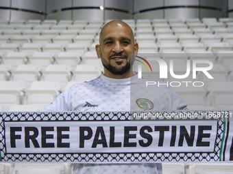 A supporter of Palestine cheers for their team before the FIFA World Cup 2026 Qualification 3rd Round group B match between Palestine and Ku...