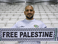 A supporter of Palestine cheers for their team before the FIFA World Cup 2026 Qualification 3rd Round group B match between Palestine and Ku...