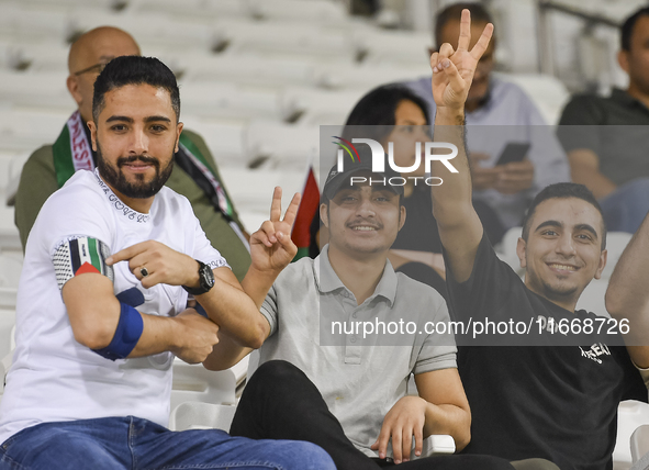 Fans of Palestine cheer during the FIFA World Cup 2026 Asian Qualifiers third round group B match between Palestine and Kuwait at Jassim Bin...