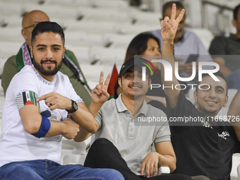 Fans of Palestine cheer during the FIFA World Cup 2026 Asian Qualifiers third round group B match between Palestine and Kuwait at Jassim Bin...