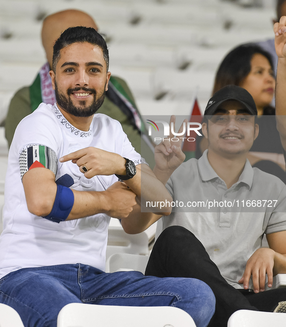 Fans of Palestine cheer during the FIFA World Cup 2026 Asian Qualifiers third round group B match between Palestine and Kuwait at Jassim Bin...