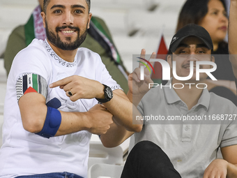 Fans of Palestine cheer during the FIFA World Cup 2026 Asian Qualifiers third round group B match between Palestine and Kuwait at Jassim Bin...