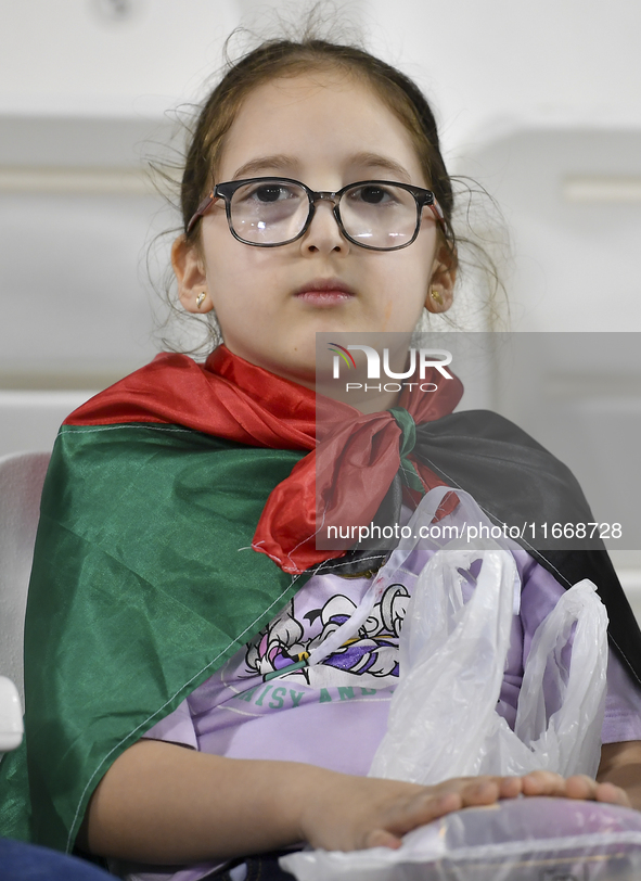 A fan of Palestine poses inside the stadium before the FIFA World Cup 2026 Asian Qualifiers third round group B match between Palestine and...