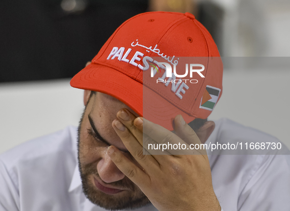 A fan of Palestine poses inside the stadium before the FIFA World Cup 2026 Asian Qualifiers third round group B match between Palestine and...