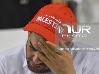 A fan of Palestine poses inside the stadium before the FIFA World Cup 2026 Asian Qualifiers third round group B match between Palestine and...