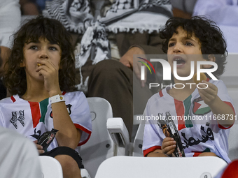 Fans of Palestine cheer during the FIFA World Cup 2026 Asian Qualifiers third round group B match between Palestine and Kuwait at Jassim Bin...