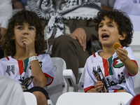 Fans of Palestine cheer during the FIFA World Cup 2026 Asian Qualifiers third round group B match between Palestine and Kuwait at Jassim Bin...