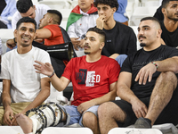 Evacuees from Gaza cheer for the Palestine national team during the FIFA World Cup 2026 Asian Qualifiers third round group B match between P...