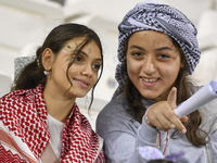 Evacuees from Gaza cheer for the Palestine national team during the FIFA World Cup 2026 Asian Qualifiers third round group B match between P...