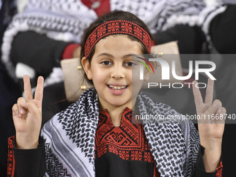 Evacuees from Gaza cheer for the Palestine national team during the FIFA World Cup 2026 Asian Qualifiers third round group B match between P...