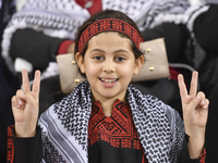 Evacuees from Gaza cheer for the Palestine national team during the FIFA World Cup 2026 Asian Qualifiers third round group B match between P...