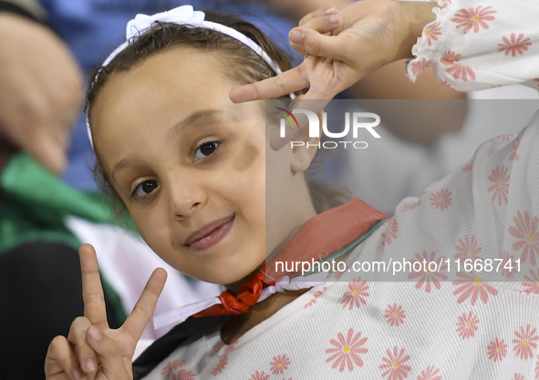 Evacuees from Gaza cheer for the Palestine national team during the FIFA World Cup 2026 Asian Qualifiers third round group B match between P...