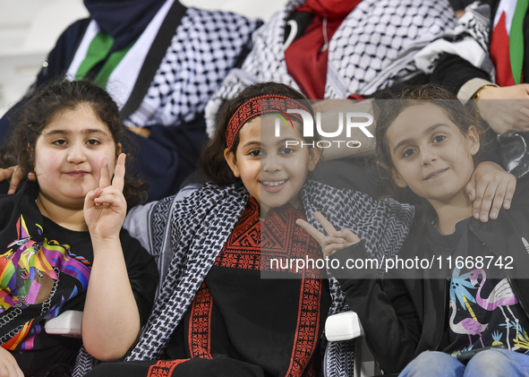 Evacuees from Gaza cheer for the Palestine national team during the FIFA World Cup 2026 Asian Qualifiers third round group B match between P...