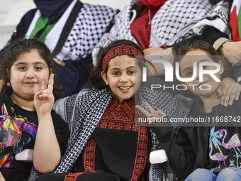 Evacuees from Gaza cheer for the Palestine national team during the FIFA World Cup 2026 Asian Qualifiers third round group B match between P...