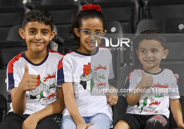 Fans of Palestine cheer during the FIFA World Cup 2026 Asian Qualifiers third round group B match between Palestine and Kuwait at Jassim Bin...