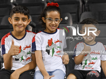 Fans of Palestine cheer during the FIFA World Cup 2026 Asian Qualifiers third round group B match between Palestine and Kuwait at Jassim Bin...