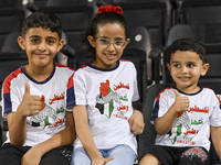 Fans of Palestine cheer during the FIFA World Cup 2026 Asian Qualifiers third round group B match between Palestine and Kuwait at Jassim Bin...