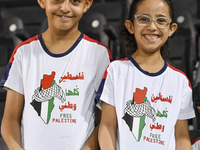 Fans of Palestine cheer during the FIFA World Cup 2026 Asian Qualifiers third round group B match between Palestine and Kuwait at Jassim Bin...