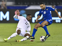 Mousa Farawi of Palestine battles for the ball with Moaath Alenezi of Kuwait during the FIFA World Cup 2026 Qualification 3rd Round group B...