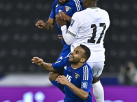 Mousa Farawi (C) of Palestine battles for the ball with Fahad Alhajeri of Kuwait during the FIFA World Cup 2026 Qualification 3rd Round grou...